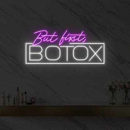 Photo of the 'But first, BOTOX' neon sign glowing in deep pink against a styled interior wall.