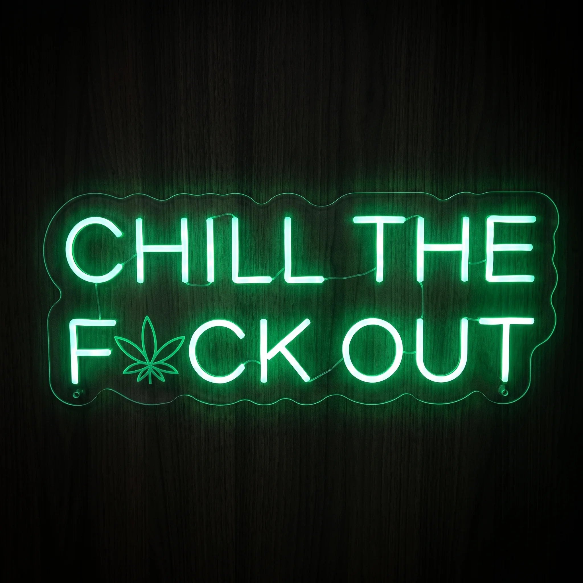 Chill The F*ck Out quote LED neon sign featuring bright green lettering with a cannabis leaf icon on a clear acrylic backing.