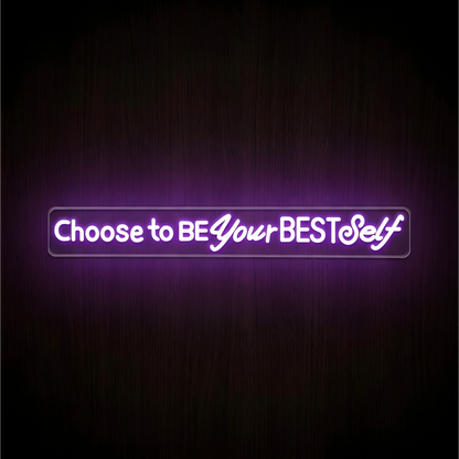 “Choose to BE Your BEST Self” LED Neon Sign with glowing purple and white lettering on clear acrylic backing against a dark wood background, suited to bedroom and home office decor.