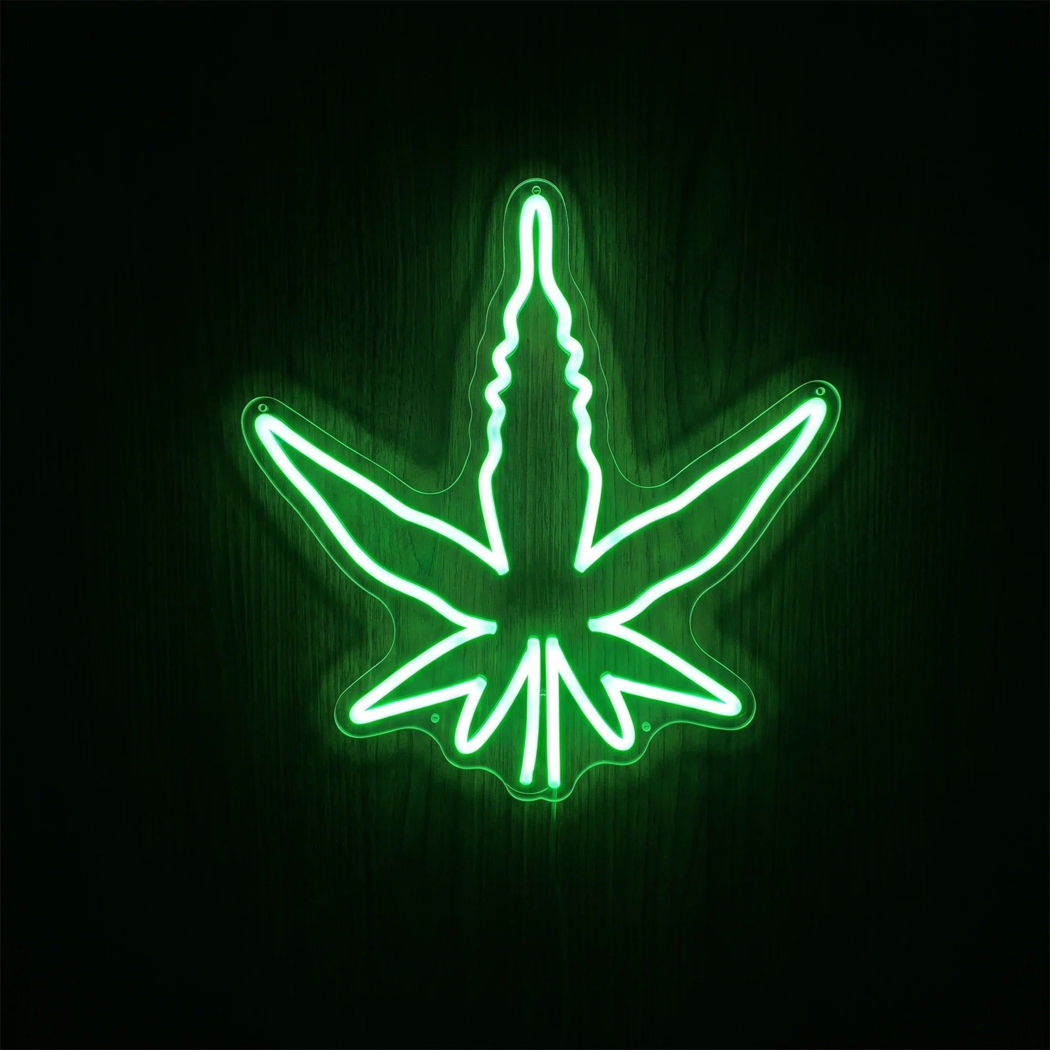 Classic green cannabis leaf LED neon sign on acrylic backing for cannabis wall décor, dispensary display, or adult recreational interiors.