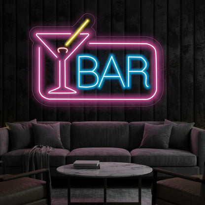 Photo of the 'BAR' neon sign glowing in multi-color against a styled interior wall.