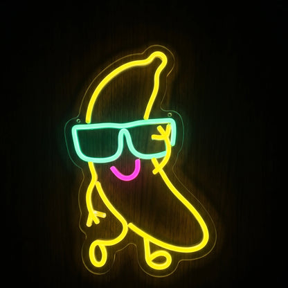 Cool banana LED neon sign with yellow banana character, aqua sunglasses, pink smile, and clear acrylic backing.