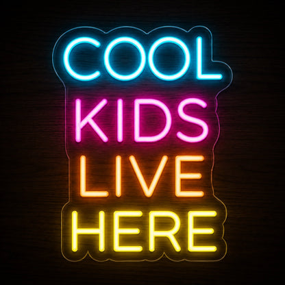 COOL KIDS LIVE HERE LED neon sign in blue, pink, orange, and yellow on clear acrylic backing.
