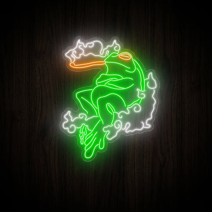 Cosmic Smoking Frog LED neon sign featuring a relaxed green frog smoking with glowing white clouds on a precision-cut clear acrylic backing.