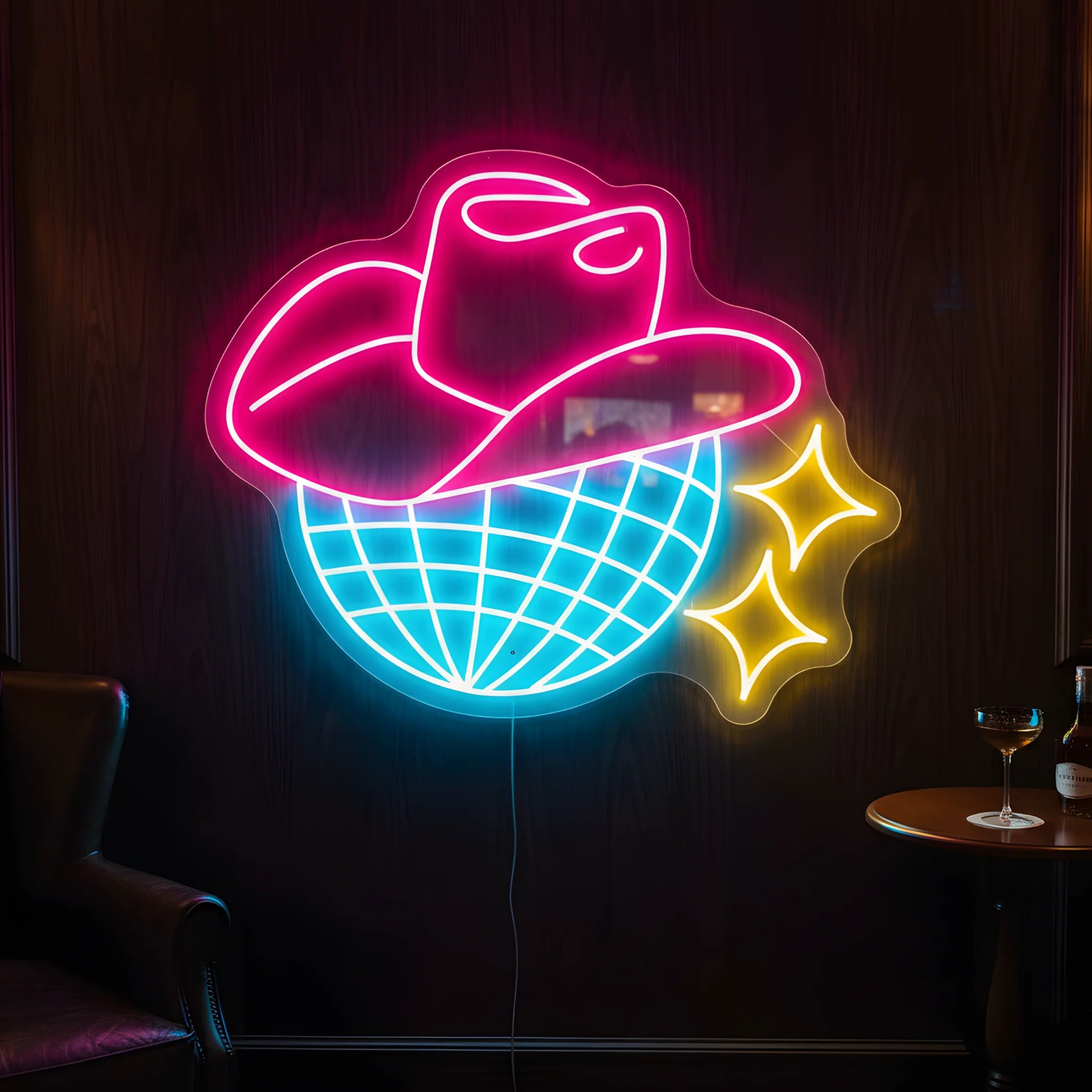 Photo of the 'Cowboy Disco' neon sign glowing in multi-color against a western disco-inspired wall.