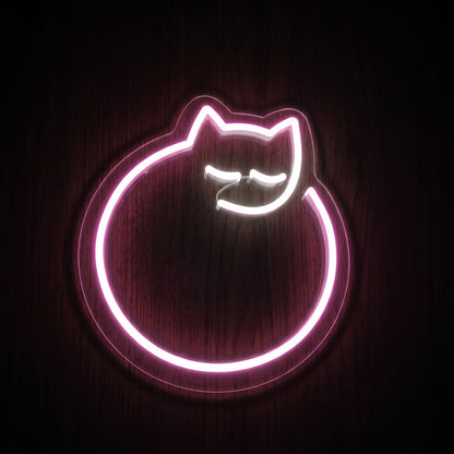 Curled sleeping cat LED neon sign with soft pink outline, white facial details, and clear acrylic backing.

