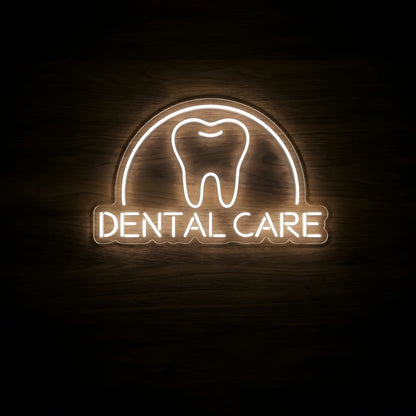 Dental Care Tooth Emblem LED neon sign featuring a warm white tooth outline beneath a semicircular arch with glowing DENTAL CARE lettering on clear acrylic backing for dental clinic wall decor.