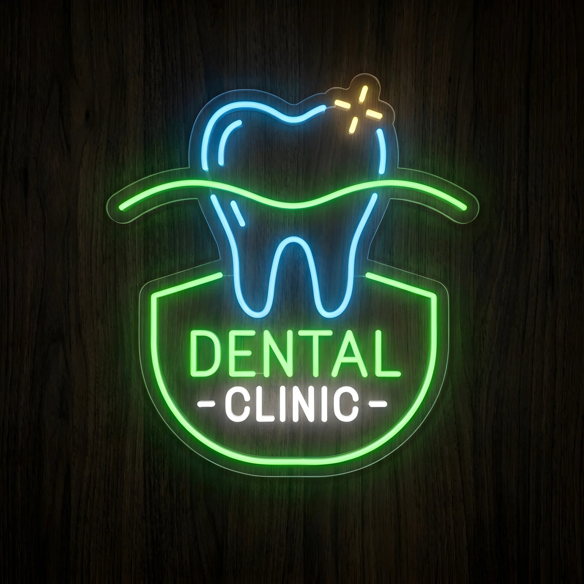 Dental Clinic Green Emblem LED neon sign featuring a glowing blue tooth with yellow sparkle, green circular emblem, green Dental lettering, and white Clinic lettering on clear acrylic backing against a dark wooden wall.