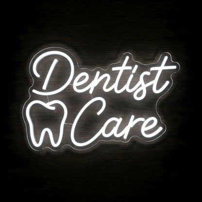 Dentist Care Script LED neon sign featuring elegant cool white Dentist Care cursive lettering and an illuminated tooth outline on clear acrylic backing for dental clinic wall decor.
