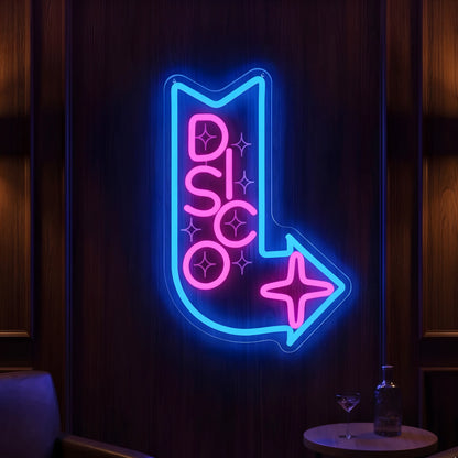 Photo of the 'Disco This Way' neon sign glowing in multi-color against a modern nightlife-inspired wall.