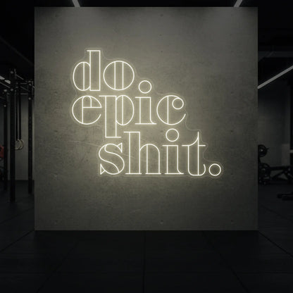  'Do Epic Shit.' neon sign glowing in warm white against a styled interior wall.