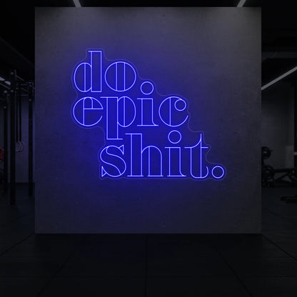  'Do Epic Shit.' neon sign glowing in deep blue against a styled interior wall.