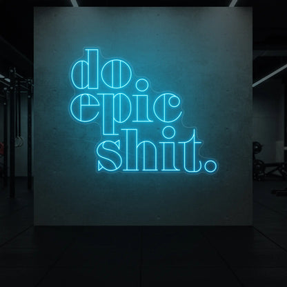  'Do Epic Shit.' neon sign glowing in ice blue against a styled interior wall.