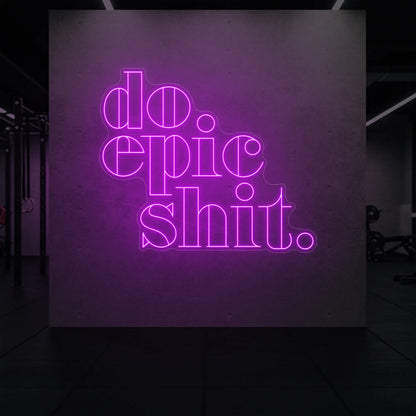 'Do Epic Shit.' neon sign glowing in deep pink against a styled interior wall.