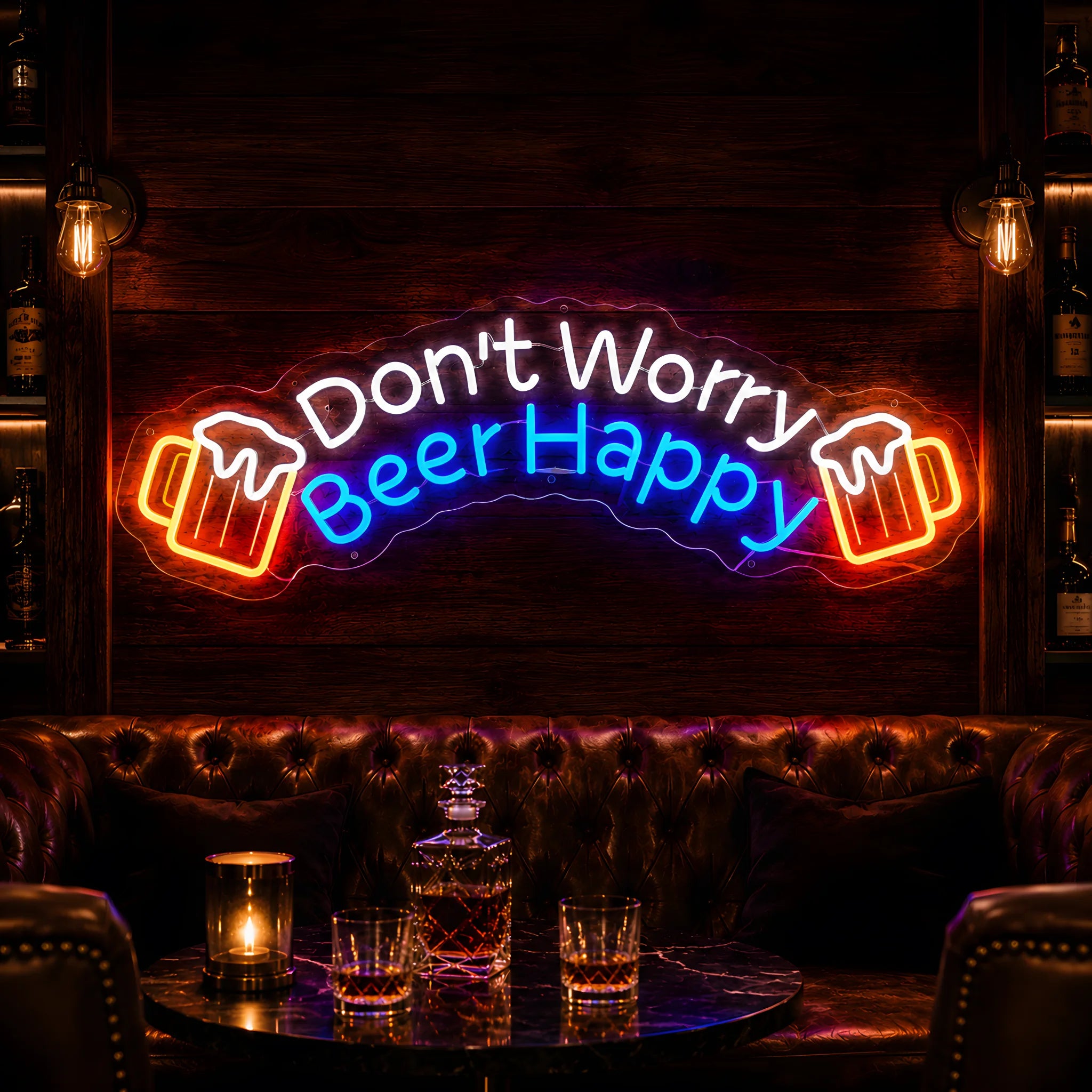 Photo of the 'Don’t Worry Beer Happy' neon sign glowing in multi-color against a cozy bar lounge wall.