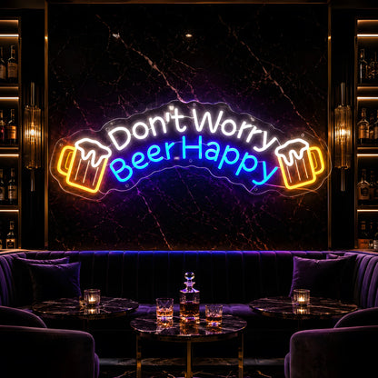 Photo of the 'Don’t Worry Beer Happy' neon sign glowing in multi-color against a cozy bar lounge wall.