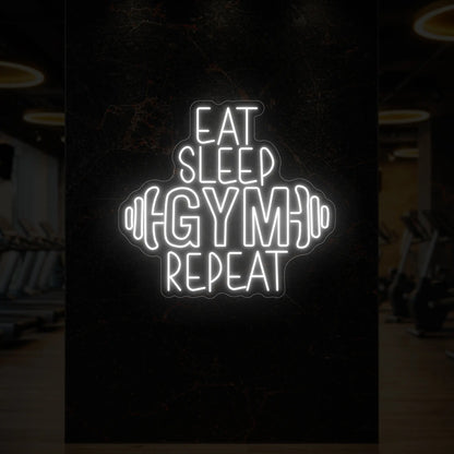 'Eat Sleep Gym Repeat (with Dumbbell)' neon sign glowing in cool white against a styled interior wall.
