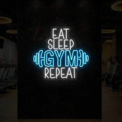  'Eat Sleep Gym Repeat (with Dumbbell)' neon sign glowing in ice blue against a styled interior wall.