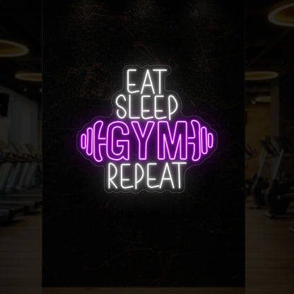 'Eat Sleep Gym Repeat (with Dumbbell)' neon sign glowing in deep pink against a styled interior wall.