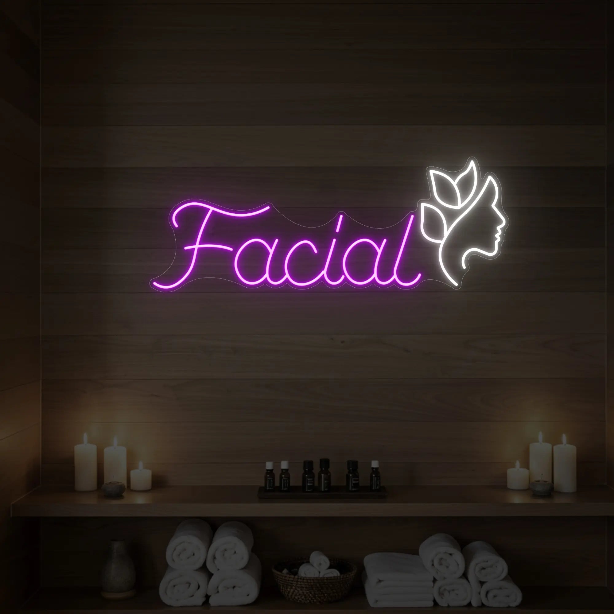 Photo of the 'Facial' neon sign with a botanical face silhouette glowing in deep pink against a styled interior wall.