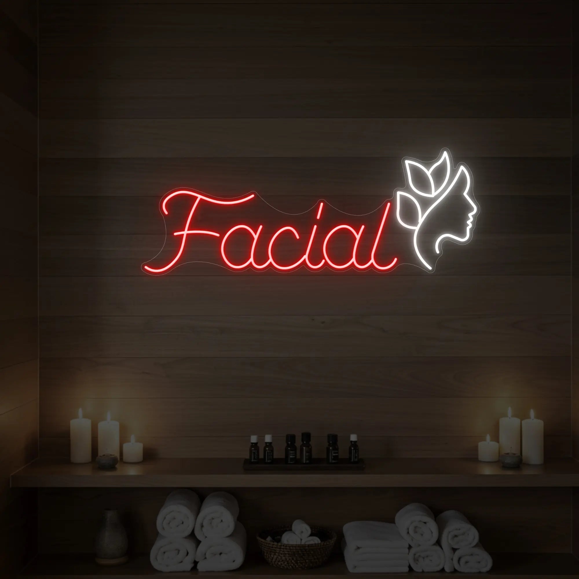 Photo of the 'Facial' neon sign with a botanical face silhouette glowing in red against a styled interior wall.