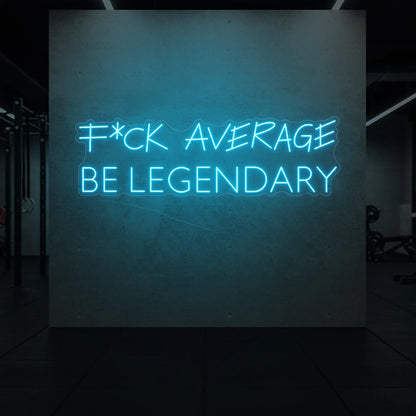  'F*ck Average Be Legendary' neon sign glowing in ice blue against a styled interior wall.