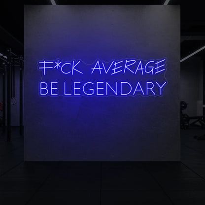 'F*ck Average Be Legendary' neon sign glowing in deep blue against a styled interior wall.