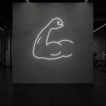  'Flexing Bicep Arm' neon sign glowing in cool white against a styled interior wall.