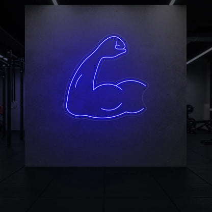 'Flexing Bicep Arm' neon sign glowing in deep blue against a styled interior wall.