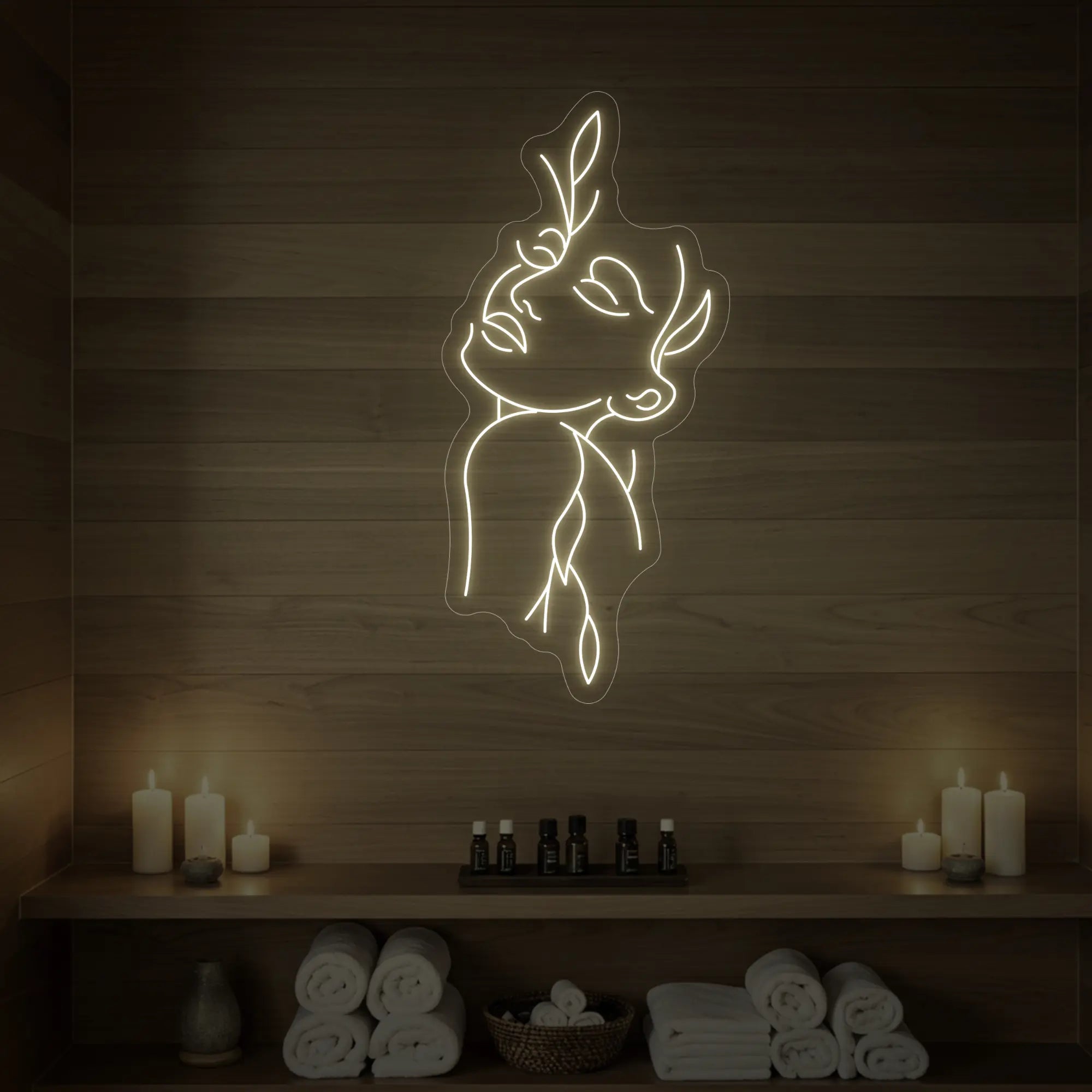 Photo of the 'Flower Girl' neon sign featuring a minimalist face and leaf line art glowing in warm white against a styled interior wall.