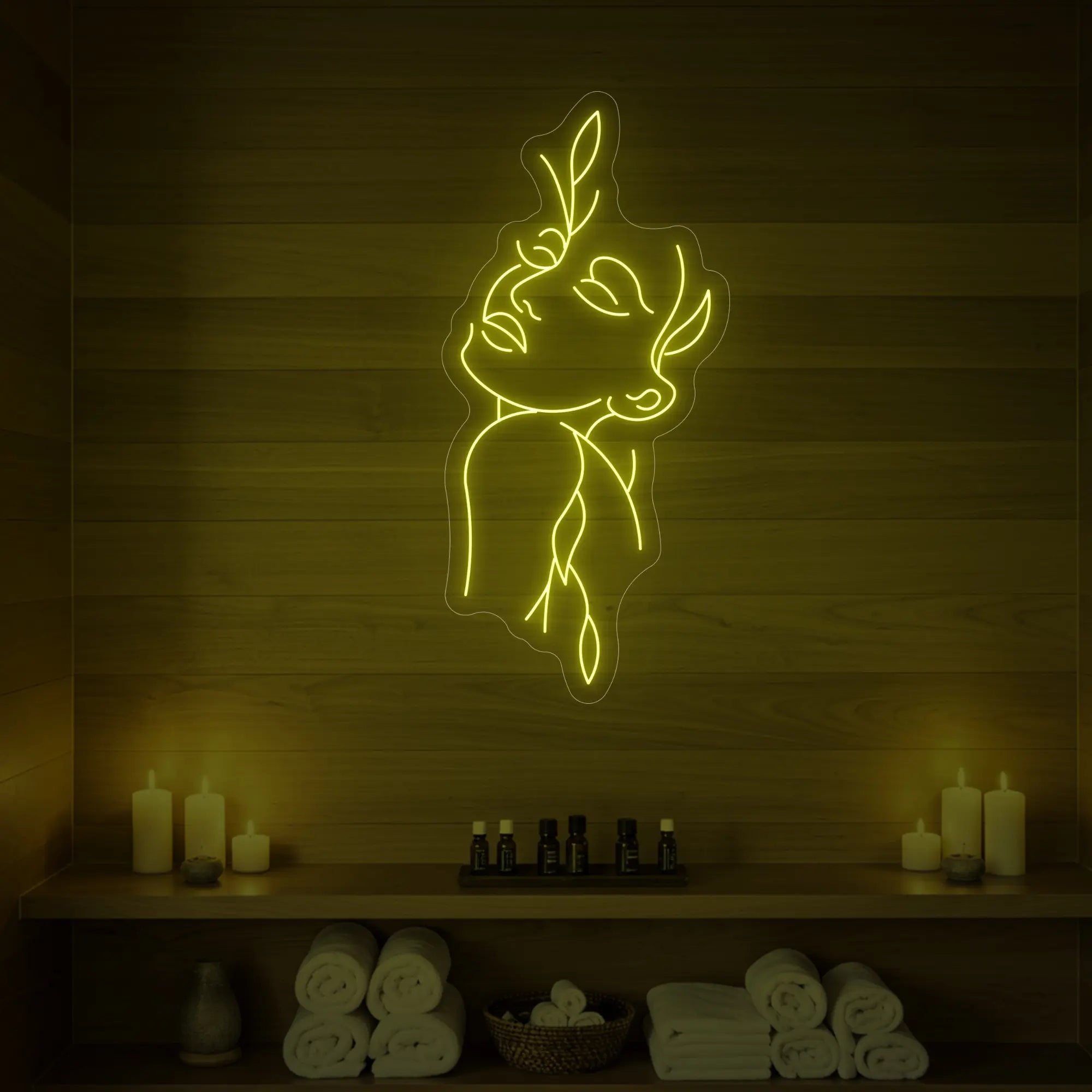 Photo of the 'Flower Girl' neon sign featuring a minimalist face and leaf line art glowing in lemon yellow against a styled interior wall.