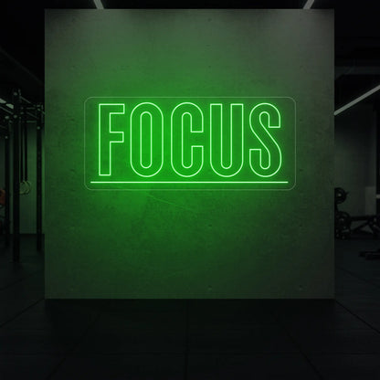  'Fortune Favours the Brave' neon sign glowing in green against a styled interior wall.