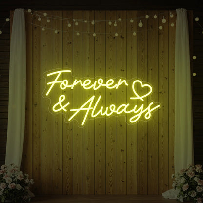 Photo of the 'Forever & Always' neon sign glowing in lemon yellow against a styled interior wall.