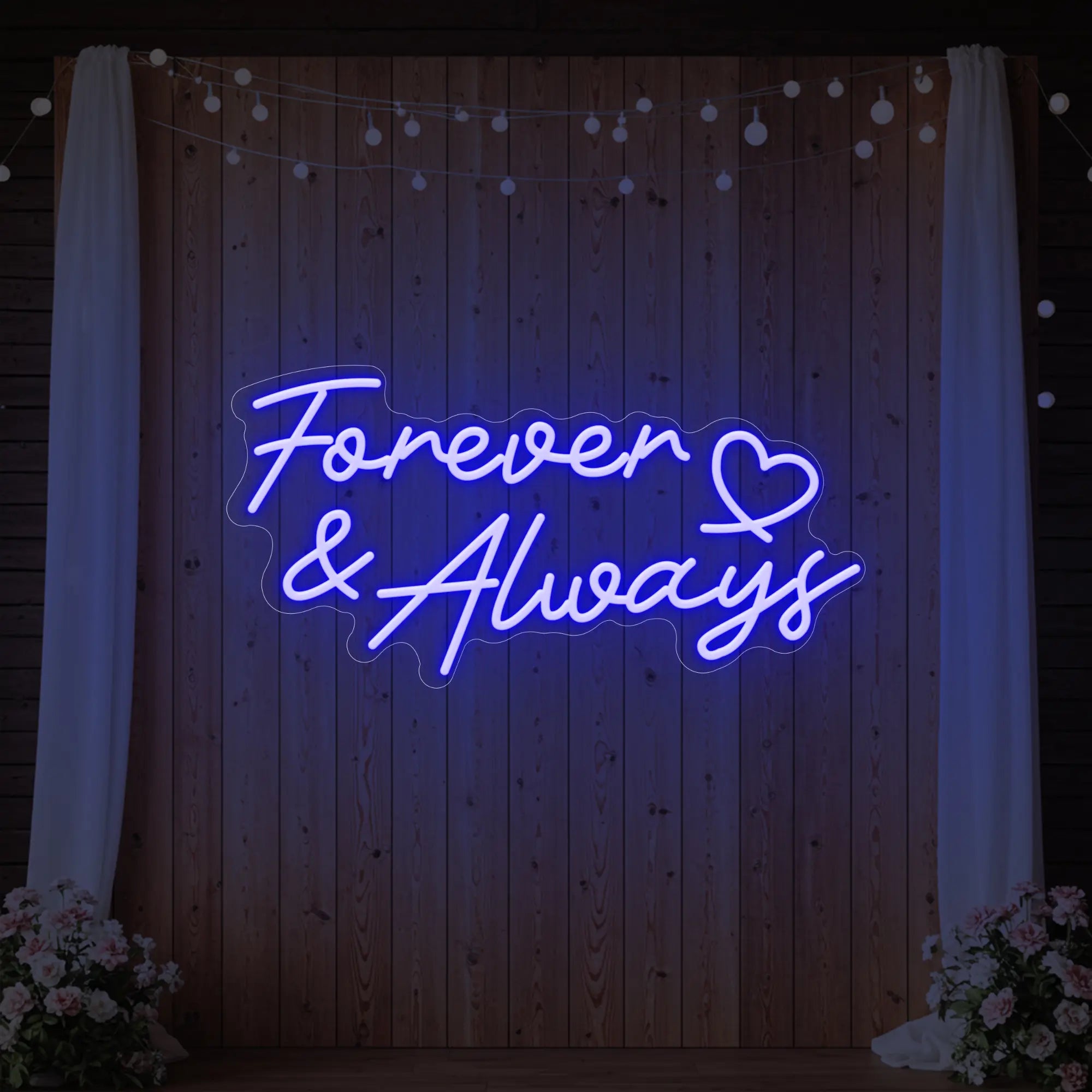 Photo of the 'Forever & Always' neon sign glowing in deep blue against a styled interior wall.