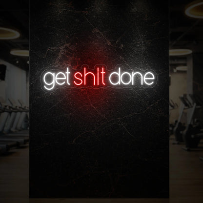 'Get Shit Done' neon sign glowing in red against a styled interior wall.