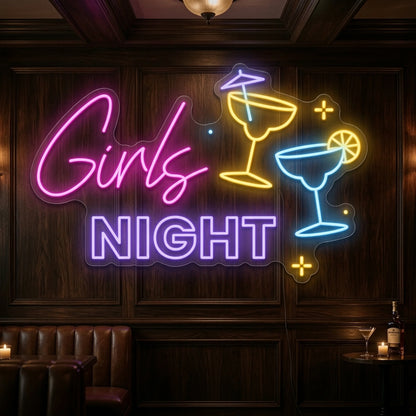 Photo of the 'Girls Night' neon sign glowing in multi-color against a styled interior wall.