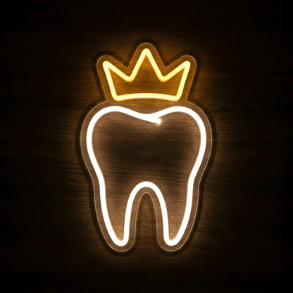 Golden Crown Dental Tooth LED neon sign featuring a glowing warm white tooth outline topped with a golden-yellow crown on clear acrylic backing against a dark wooden wall.