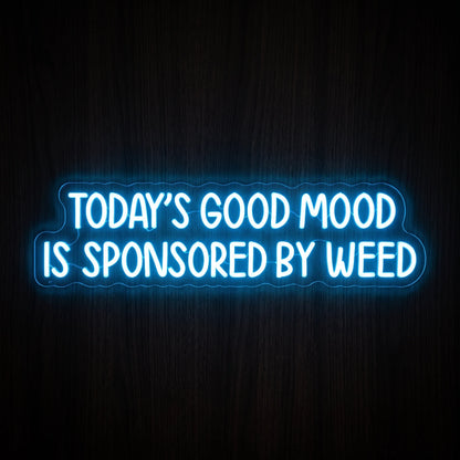 Today's Good Mood Is Sponsored By Weed LED neon sign featuring bright blue typography on a clear acrylic backing.