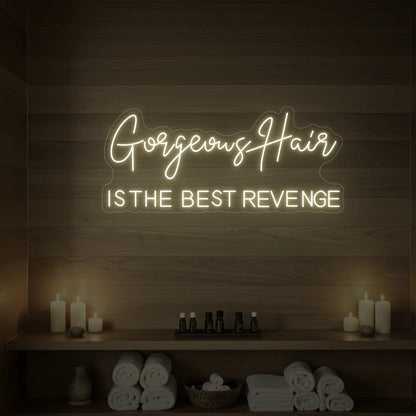 Photo of the 'Gorgeous Hair is the Best Revenge' neon sign glowing in warm white against a styled interior wall.