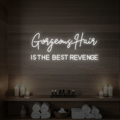Photo of the 'Gorgeous Hair is the Best Revenge' neon sign glowing in cool white against a styled interior wall.