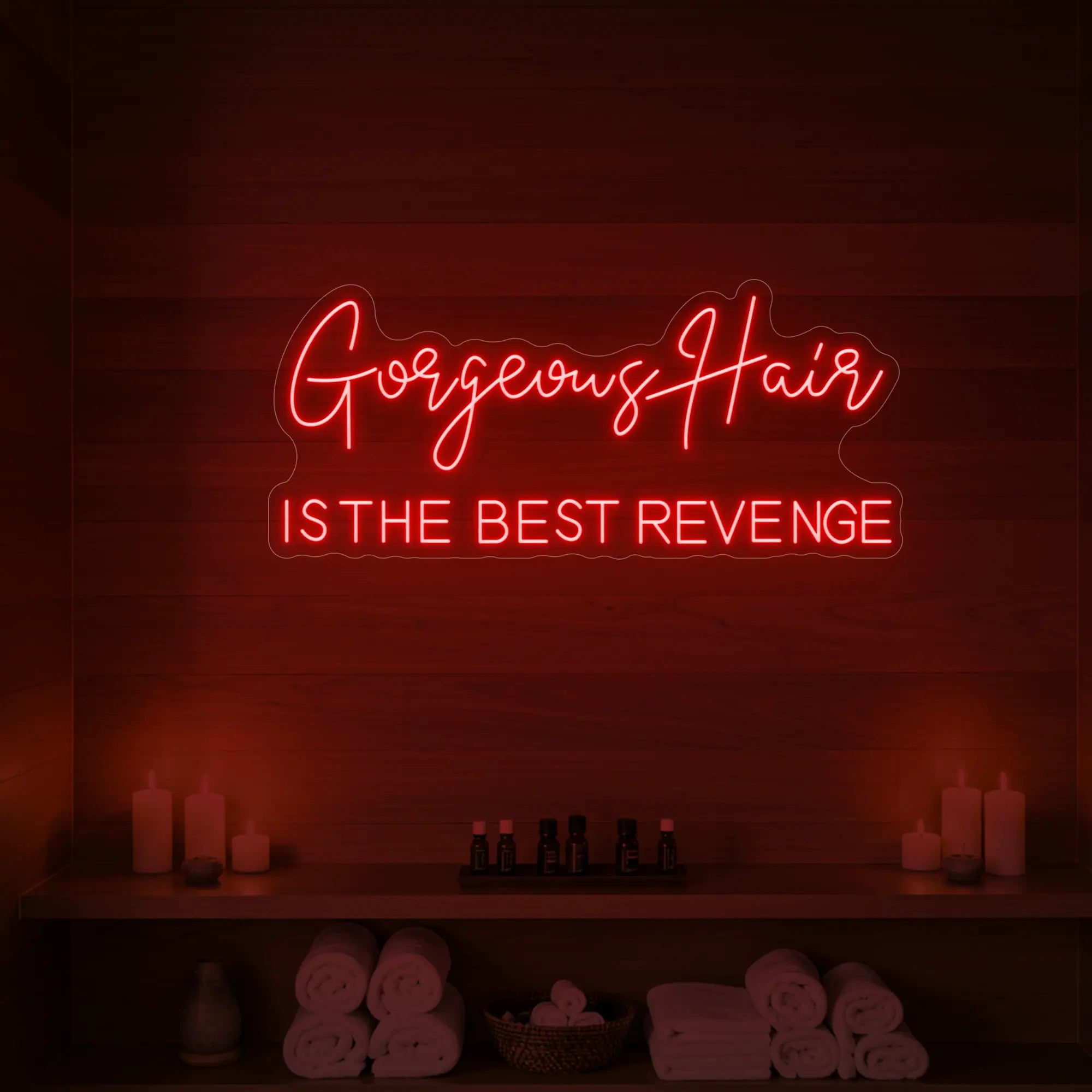 Photo of the 'Gorgeous Hair is the Best Revenge' neon sign glowing in red against a styled interior wall.