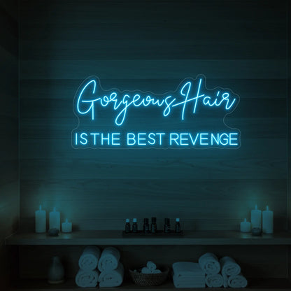 Photo of the 'Gorgeous Hair is the Best Revenge' neon sign glowing in ice blue against a styled interior wall.