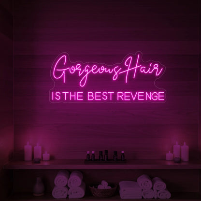 Photo of the 'Gorgeous Hair is the Best Revenge' neon sign glowing in light pink against a styled interior wall.