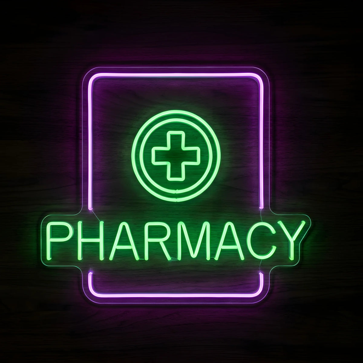Green Cross Pharmacy LED Neon Sign featuring a glowing green medical cross inside a circular outline, green PHARMACY lettering, and a purple rectangular border on clear acrylic against a dark wooden wall.