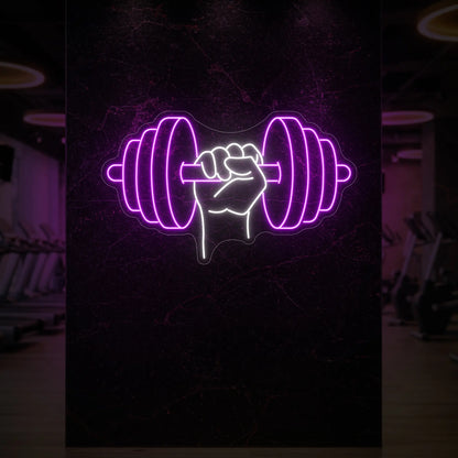 'Hand Holding a Weight' neon sign glowing in deep pink against a styled interior wall.