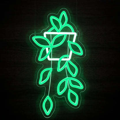 Hanging Vine LED Neon Sign featuring bright green cascading leaves and a white outlined hanging planter on clear acrylic backing.