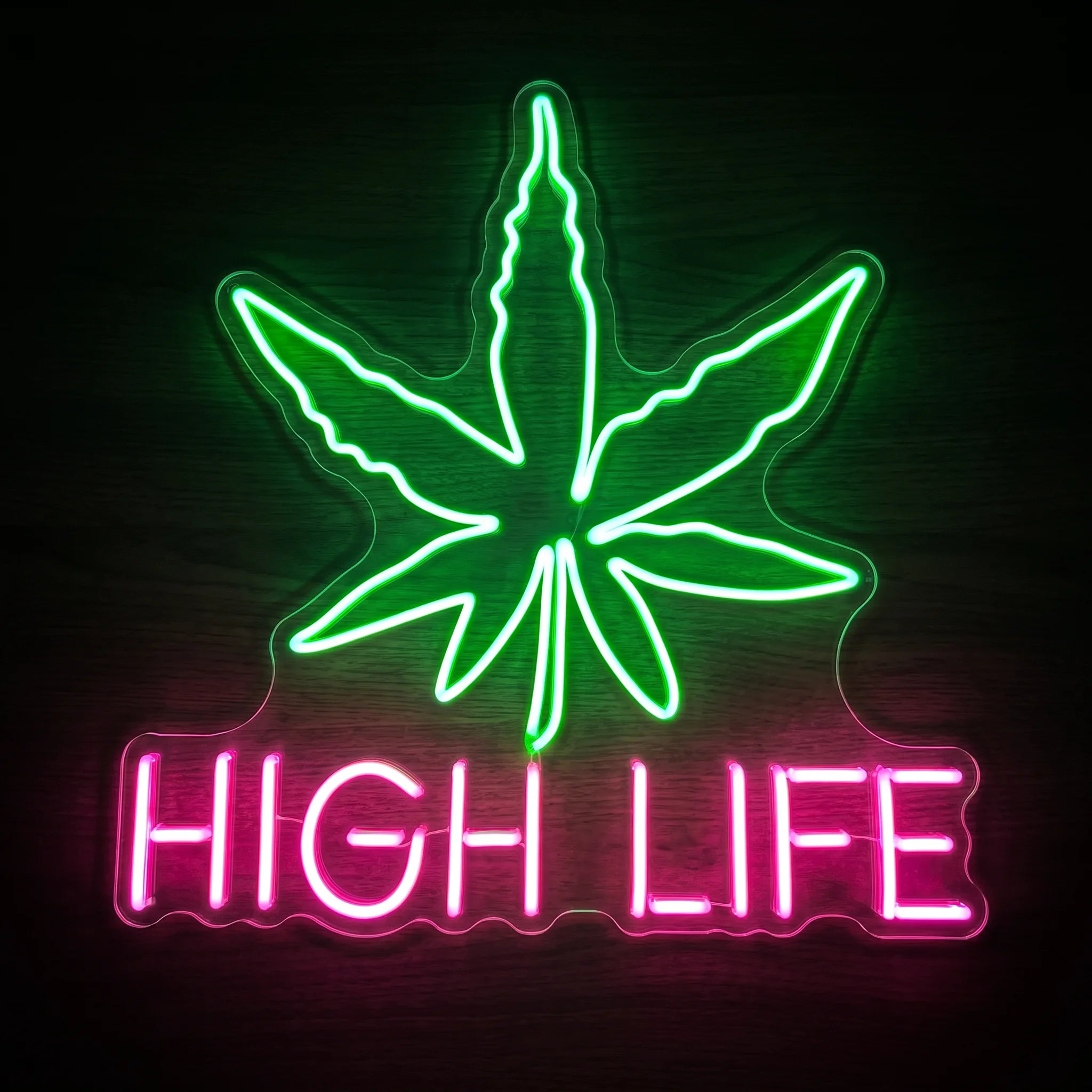 High Life cannabis leaf LED neon sign with a green cannabis leaf, pink HIGH LIFE lettering, and clear acrylic backing for recreational wall décor.