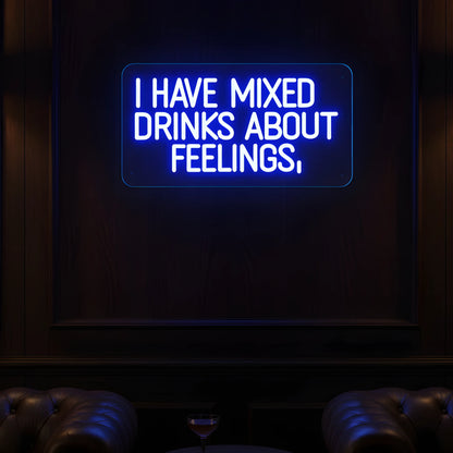 Photo of the 'I Have Mixed Drinks About Feelings' neon sign glowing in blue against a styled interior wall.