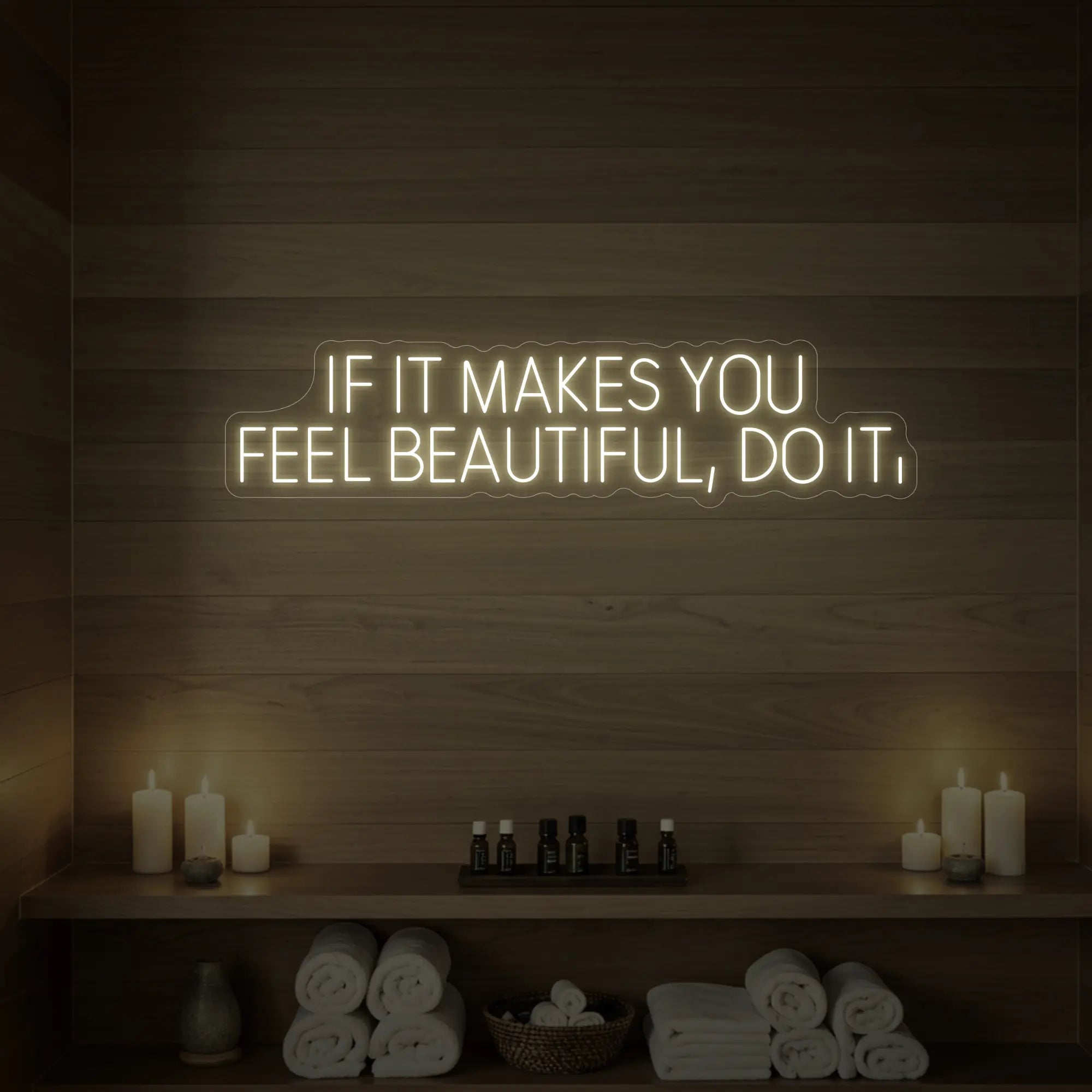 Photo of the 'IF IT MAKES YOU FEEL BEAUTIFUL, DO IT.' neon sign glowing in warm white against a styled interior wall.