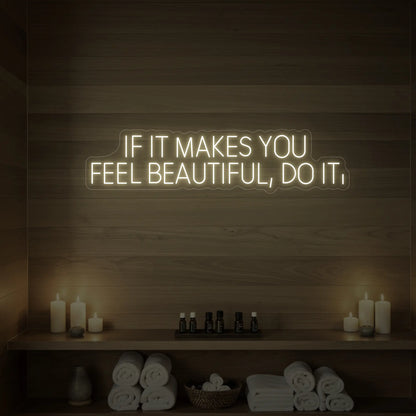 Photo of the 'IF IT MAKES YOU FEEL BEAUTIFUL, DO IT.' neon sign glowing in warm white against a styled interior wall.